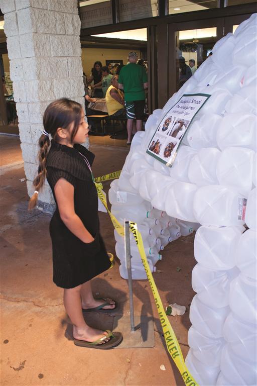 Molokai keiki Lilia Tangonan, 7, checks out an igloo sculpture made entirely of plastic bottles.
