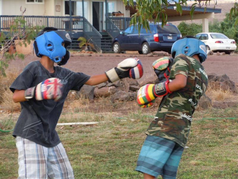 Two young Molokai boxers spar during practice at the home of their coach, Tomasito Manangan. Photo by Catherine Cluett