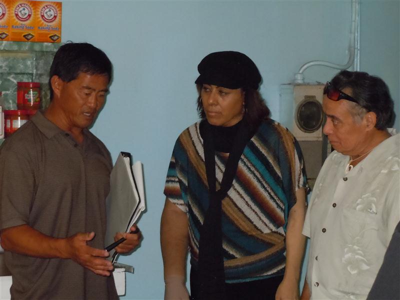 Inspector Dean Kagawa explains the violations to Rep. Mele Carroll and County Councilman Danny Mateo. Photo by Catherine Cluett