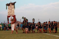 Makahiki competitors enter the game arena with their ho`okupu to Lono.