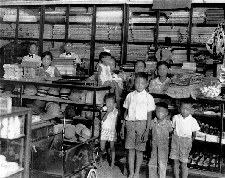 Inside Misaki’s in its original building, showing hats, cloth, shoes and other items for sale. Back row left to right: Friend and store clerk Masato Yoshiyoka, sales clerk Margaret Matsumura, Masataro Misaki, Uta Misaki (seated) holding daughter Irene, friend Mrs. Nishiyama, Clara (Misaki); front row Misaki children Eileen, Richard, Tadashi and Mike. Photo courtesy Irene Iwane.
